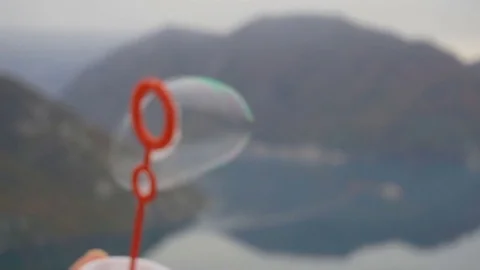 Slow motion, extreme closeup blowing soap bubbles Stock Footage 82883328