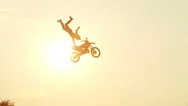 Slow Motion: Extreme Pro Motocross Biker Jumping Freestyle Trick Over The Sun Stock Footage