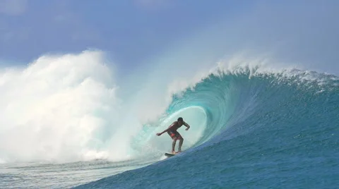 SLOW MOTION: Extreme pro surfer surfing big tube barrel wave Stock Footage 61220873