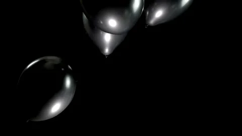 Slow Motion Fall of Black Balloons against a Clean Background with Smooth Stock Footage 303633040