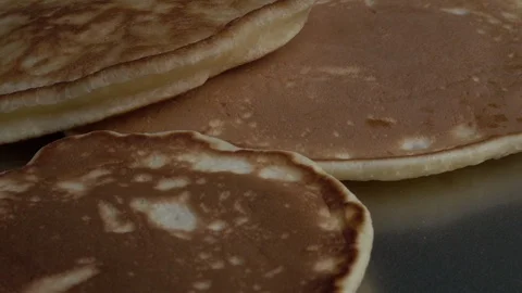 Slow motion of falling batter cakes on dark grey plate close up. Stock Footage 100236205