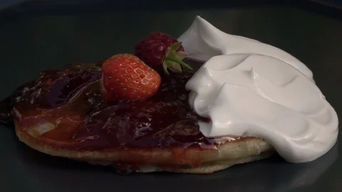 Slow motion of falling berries on batter cake with preserve and yoghurt. Stock Footage 100236045