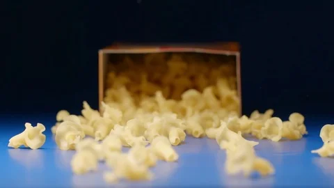 SLOW MOTION: Falling a box with a figural pasta Stock Footage 75436839