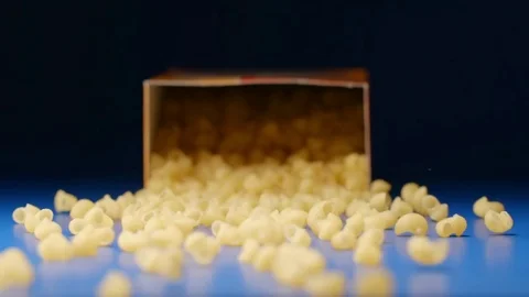 SLOW MOTION: Falling a box with a figural macaroni Vídeo Stock 75436927