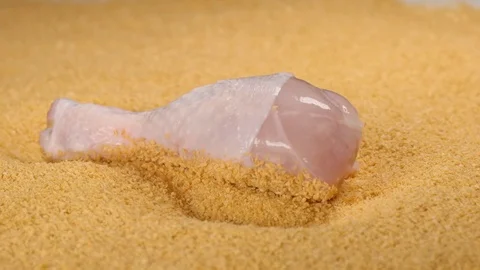 SLOW MOTION: Falling a chicken leg in a beading powder - macro shot Stock Footage 75436779