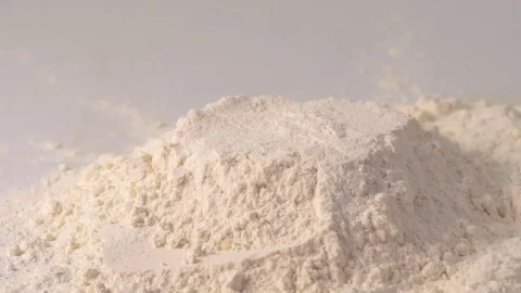 Slow motion of falling down raw egg into flour. Stock Footage 70866586