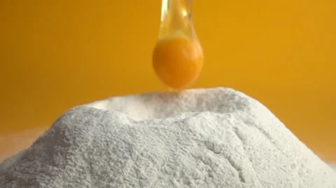 Slow motion of falling egg into flour Stock Footage 64872212
