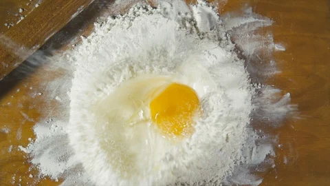 Slow Motion of Falling Egg into Flour Stock. Stock Footage 108257798
