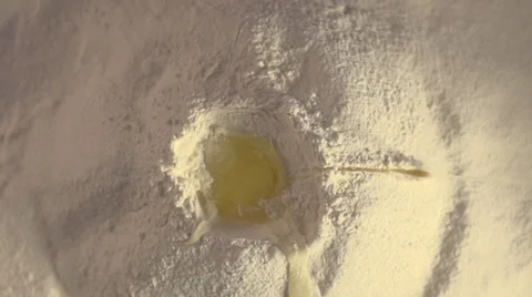 Slow motion of falling eggs into flour Stock Footage 36041076