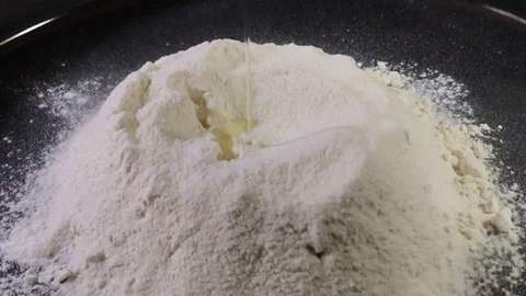 Slow motion of falling eggs into flour stock footage food. shooting with slider Vídeo Stock 75291030