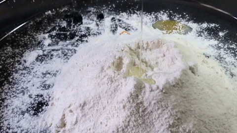 Slow motion of falling eggs into flour stock footage food. shooting with slider Stock-Footage 75291546