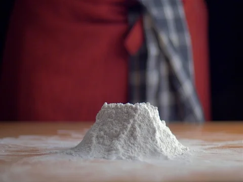 Slow motion of falling eggs into flour stock footage food Stock Footage 79662914