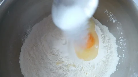 Slow motion of falling eggs into flour stock footage food Видео 86359563