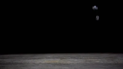 Slow motion of falling nuts on wooden table on black background. Stock Footage 101496532