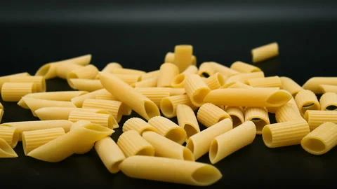Slow motion of falling raw uncooked penne pasta,italian healthy eating food Stock Footage 200972538