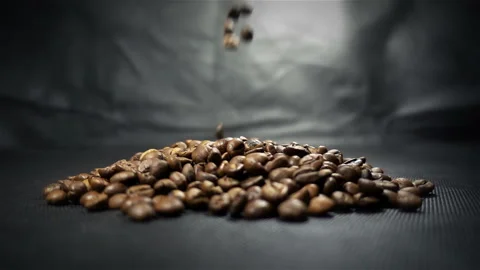 Slow Motion of Falling Roasted Coffee Beans on a Black background Stock Footage 102171801