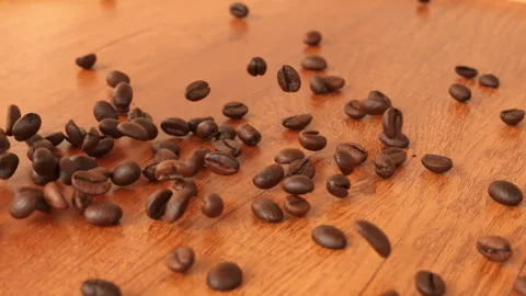 Slow Motion Falling Roasted Coffee Beans on Wooden Table Background  Vidéo 330802737