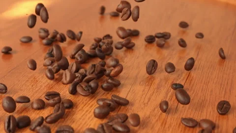 Slow Motion Falling Roasted Coffee Beans on Wooden Table Background  Stock Footage 330803041