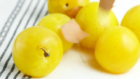 Slow motion of falling small autumn dry leaves on yellow plums Stock Footage 93144442