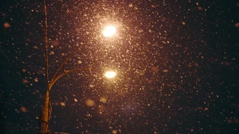 Slow motion of falling snow on the background of a lantern at night Stock Footage 248157296