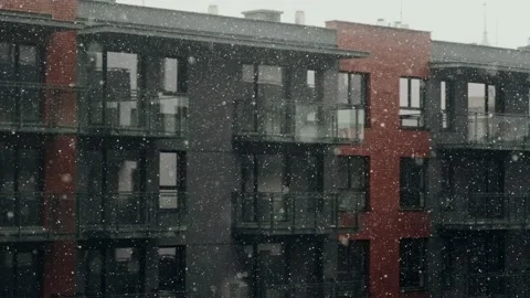 Slow motion of falling snow in city against background of a dark building. Stock Footage 146520721