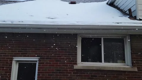 Slow Motion Falling Snow, Tilt Down Side of Brick House Video stock 196040611