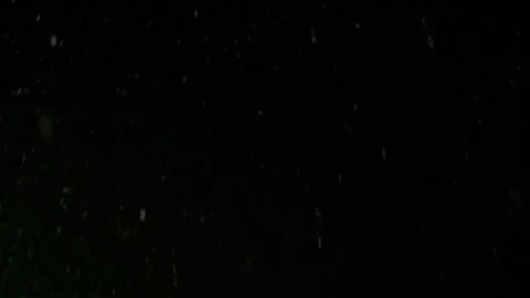 Slow Motion Falling Snowflakes Against Dark Night Sky Background Video stock 337408832