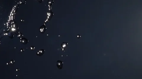 Slow motion of falling water drops on blue cloudless sky with flying flies. Stock Footage 100237075