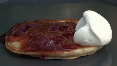 Slow motion of falling yoghurt on batter cake with strawberry preserve close up. Stock Footage 100235988