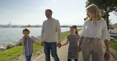 Slow Motion Of Family Talking While Walking By The Seaside Stock-Footage 123695681