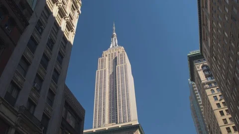 SLOW MOTION: Famous Empire State Building skyscraper surrounded by tower blocks Stock Footage 71635791