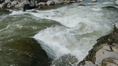 Slow motion of a fast flowing river in the rocky mountains Stock Footage 320977661