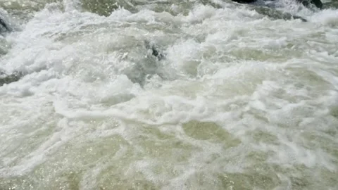 Slow motion of a fast flowing river in the rocky mountains Video stock 320977852