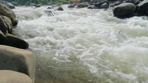 Slow motion of a fast flowing river in the rocky mountains Video stock 320977913