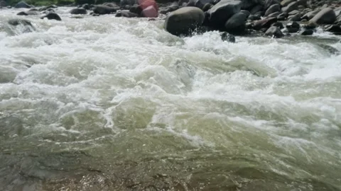 Slow motion of a fast flowing river in the rocky mountains Video stock 320977924