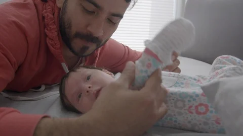 Slow motion of a father playing with his baby Stock Footage 107616379