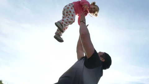 Slow motion of father throwing his adorable daughter in the air Stock Footage 90949299