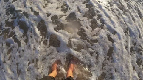 Slow Motion of Feet Walking Through Foamy Waves on Beach Stock Footage 312058920