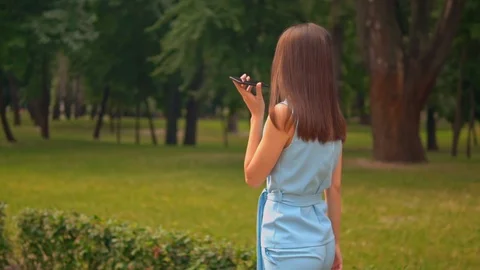 Slow motion female dictates a message use mobile Stock Footage 127847066