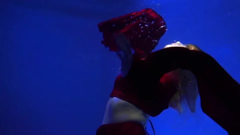 Slow Motion Female figure in a dark red dress underwater. Stock Footage 170906226