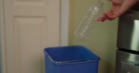 Slow Motion Female Hand Throwing Plastic Water Bottle in Recycling Bin Stock Footage 243850973