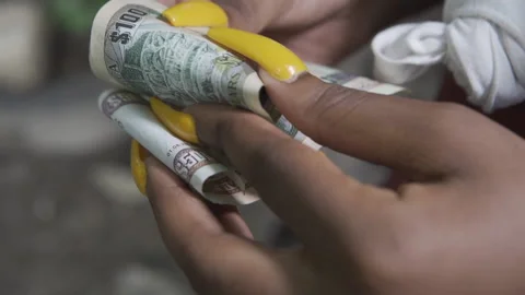 SLOW MOTION FEMALE HANDS COUNTING JAMAICAN MONEY Stock Footage 145450319