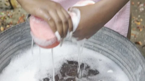 SLOW MOTION FEMALE HANDS SQUEEZING SOAPY SPONGE Stock Footage 145451484