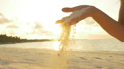 SLOW MOTION: Female playing with white sand on exotic beach Stock Footage