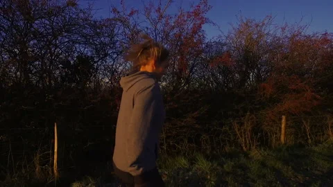 Slow Motion: Female Runner Across Countryside Fields Stock Footage 145259196