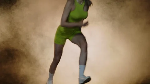 Slow motion female runner at the start close-up in the dark at the stadium Stock Footage 252066877