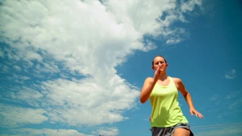 Slow motion female sprinter running and jumping floor perspective Stock Footage 115520241