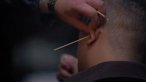 Slow motion of fine brush cleaning inside ear in Chengdu street Stock Footage 315136783