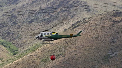 Slow Motion Fire Helicopter Dumps Water on Wild Fire Stock Footage 135852144