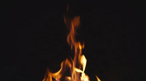 Slow motion of fire over black, with crackling sound, loopable Stock Footage